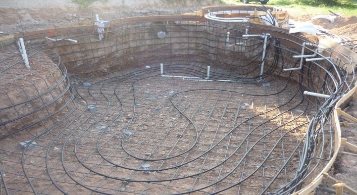 Laying geothermal loops during pool construction Laying geothermal loops during pool construction